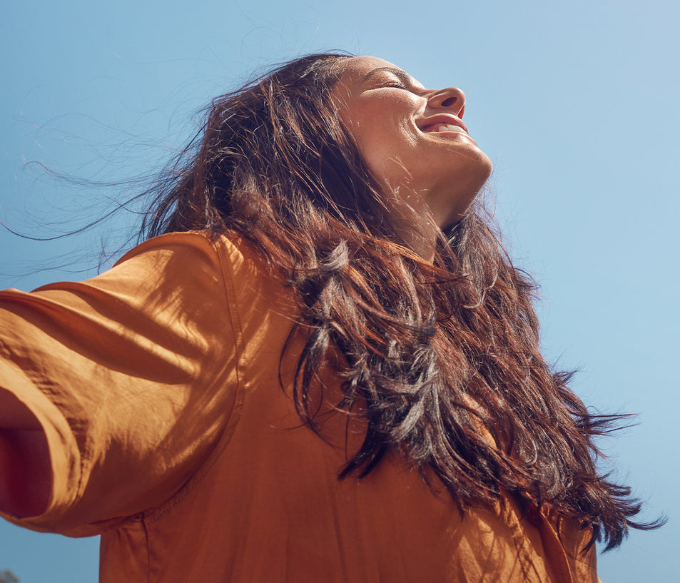 Woman In Sun Relaxing & Smiling