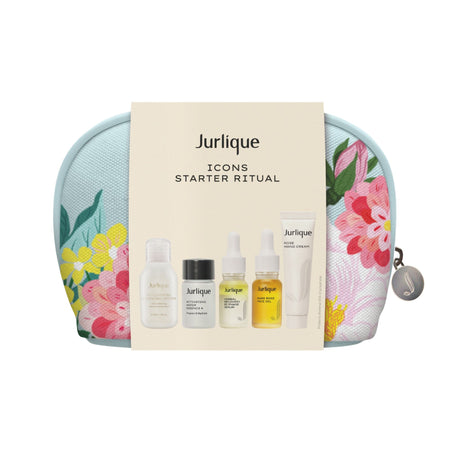 A Jurlique Icons Starter Ritual set containing various skincare products, displayed with a floral patterned background.