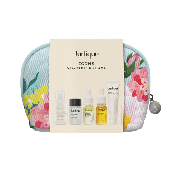 A Jurlique Icons Starter Ritual set containing various skincare products, displayed with a floral patterned background.